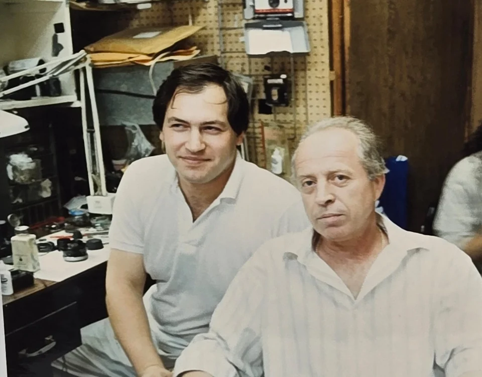 Leon Treskunov, at left, with a colleague at his first U.S. camera repair job in 1989